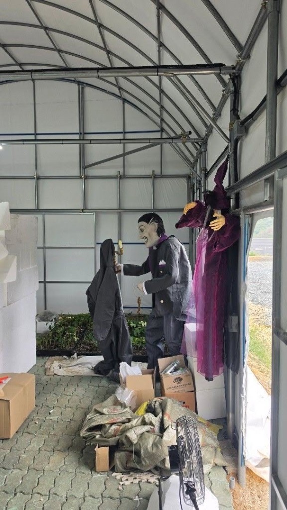 Halloween vampire and hooded figure props in workshop tent