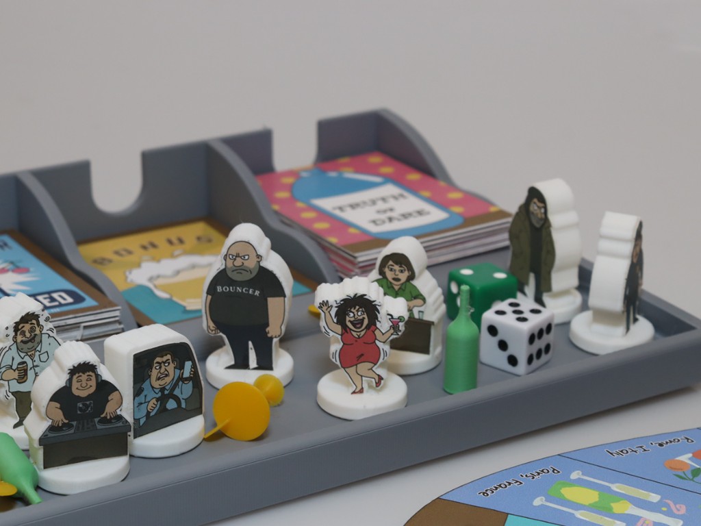 Last Call game pieces, dice, and Truth or Dare card stack in tray