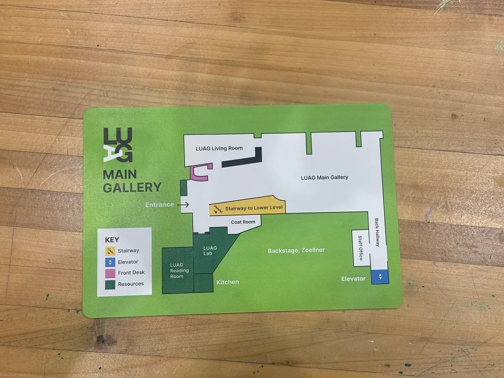 Printed LUAG Main Gallery map on wood surface
