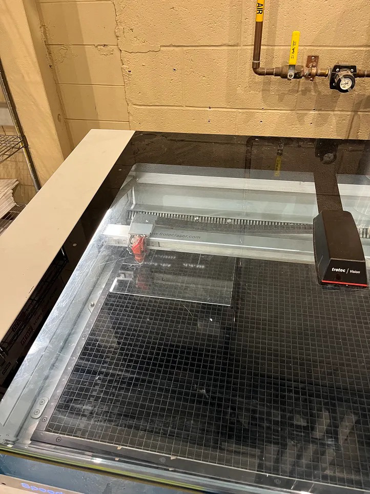 Laser cutter bed with acrylic sheet for Braille path fabrication
