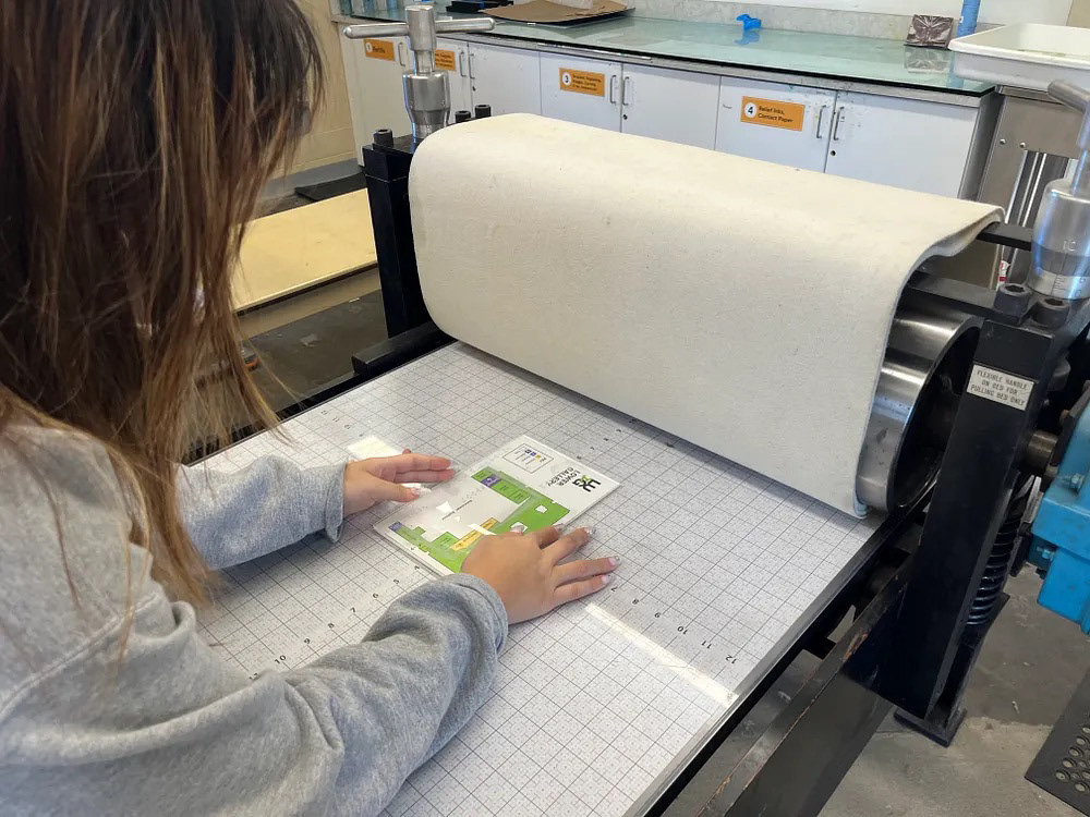 Aligning Braille map on the rolling press bed