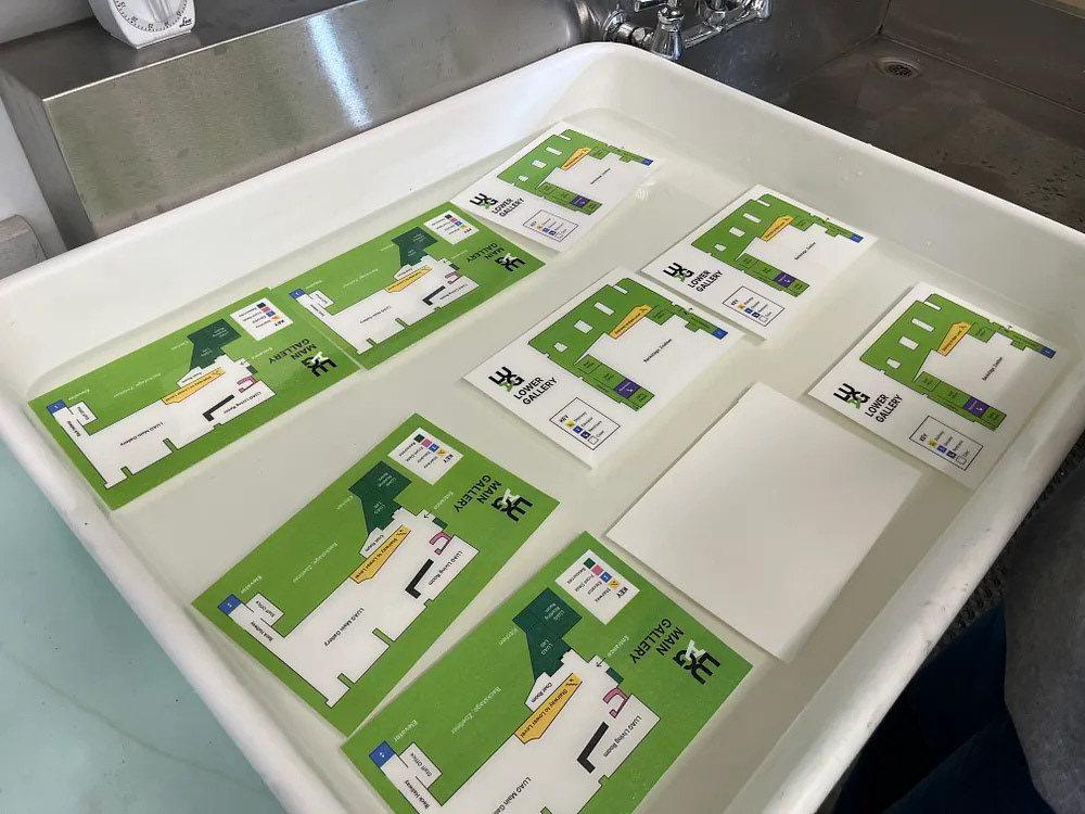Printed LUAG map cards soaking in a water tray