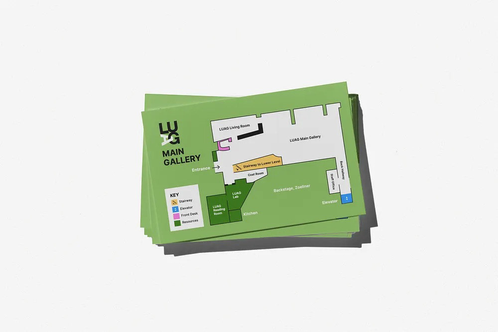 Printed LUAG Main Gallery map cards stacked on a white surface