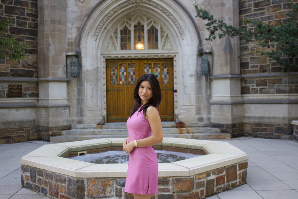 Portrait in a pink dress by a stone fountain