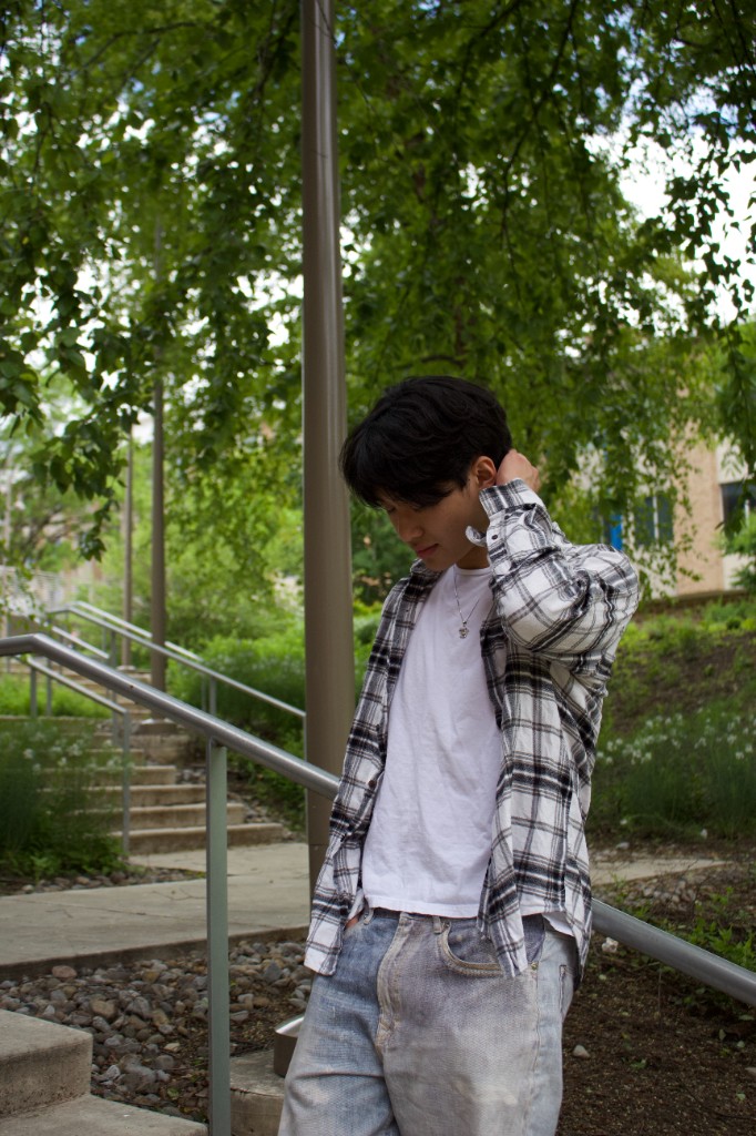 Portrait on outdoor stairs in a plaid shirt
