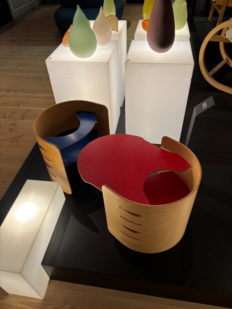 Bentwood children’s chairs with red and blue seats on display