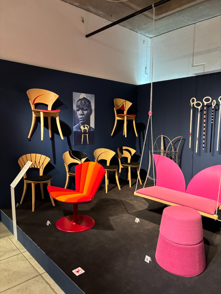 Colorful chair exhibition with wooden and pink seating pieces