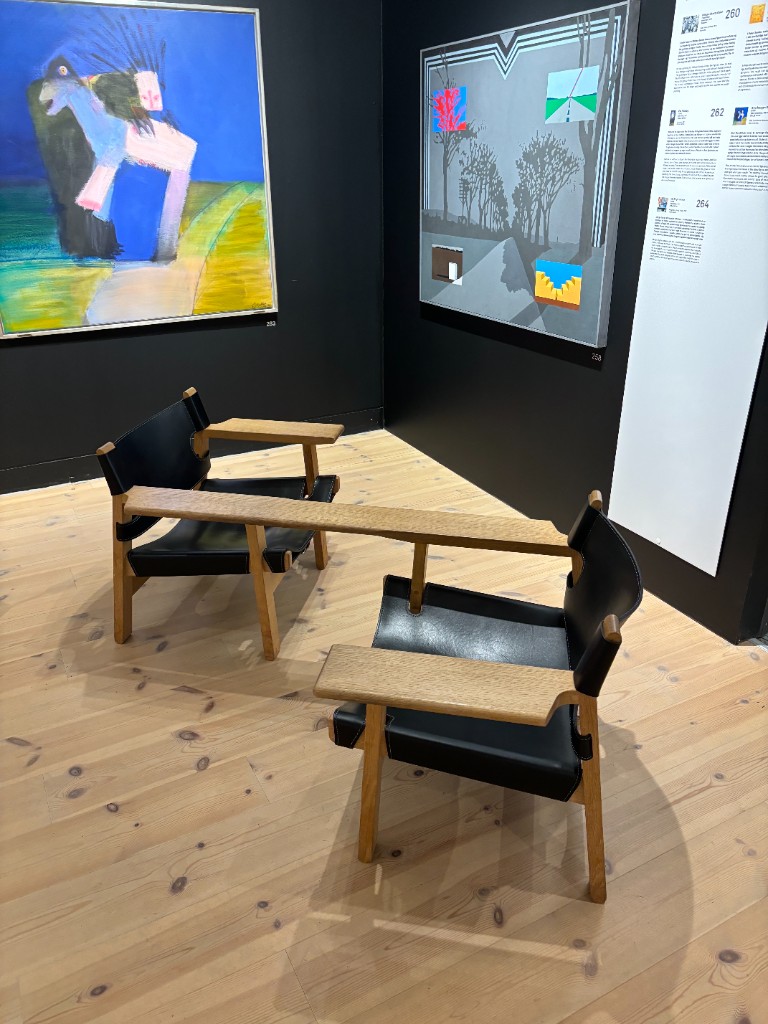 Connected wood and leather lounge chairs in a gallery