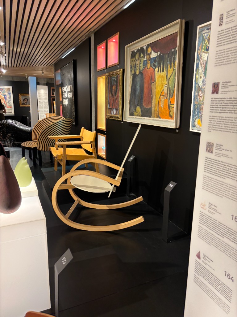 Wooden rocker and yellow lounge chair in a design museum